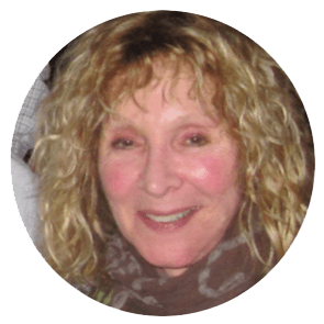 Round image of a smiling woman with curly blond hair.
